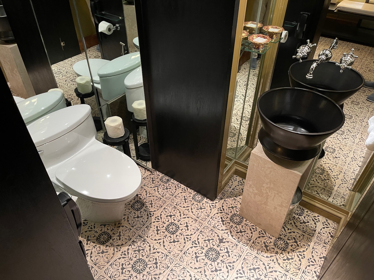 a bathroom with a black door and a black sink