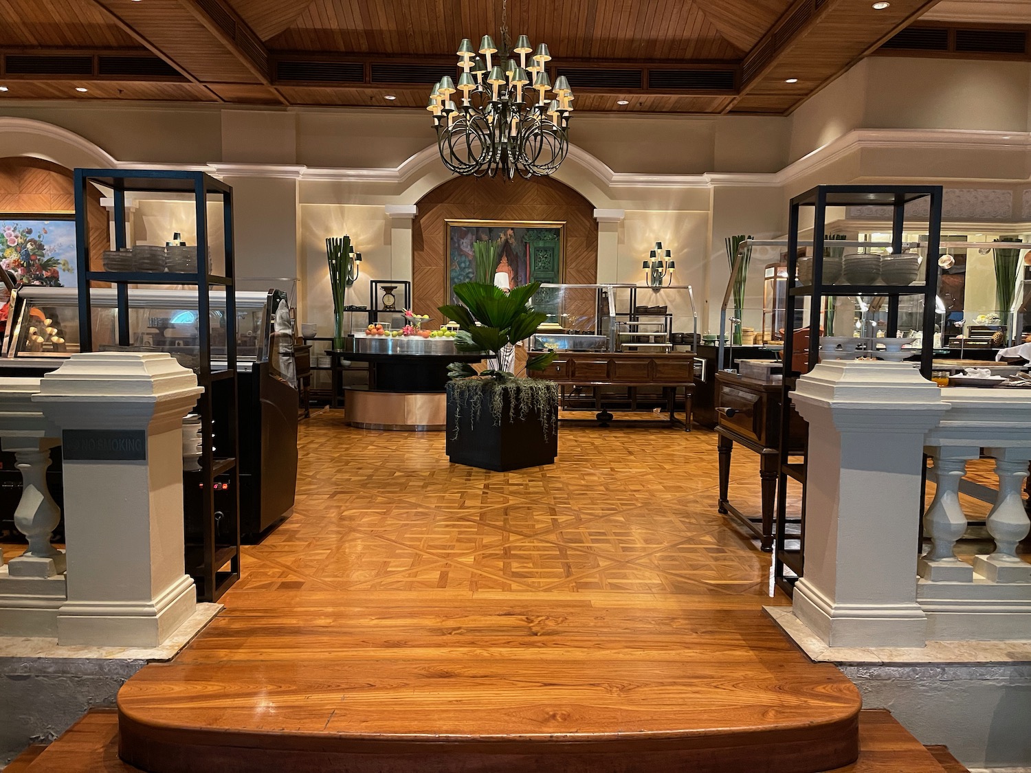 a buffet room with a chandelier and food