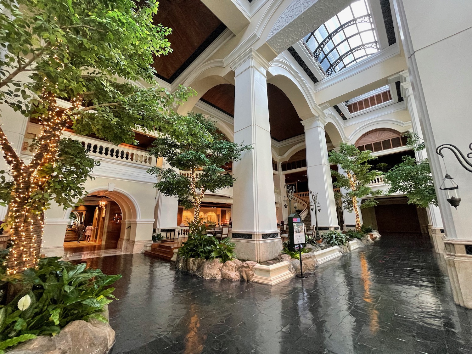 a large building with trees and a glass roof