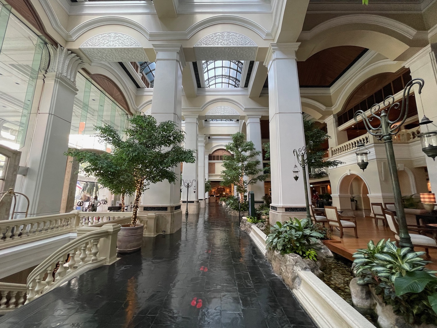 a large building with white pillars and trees