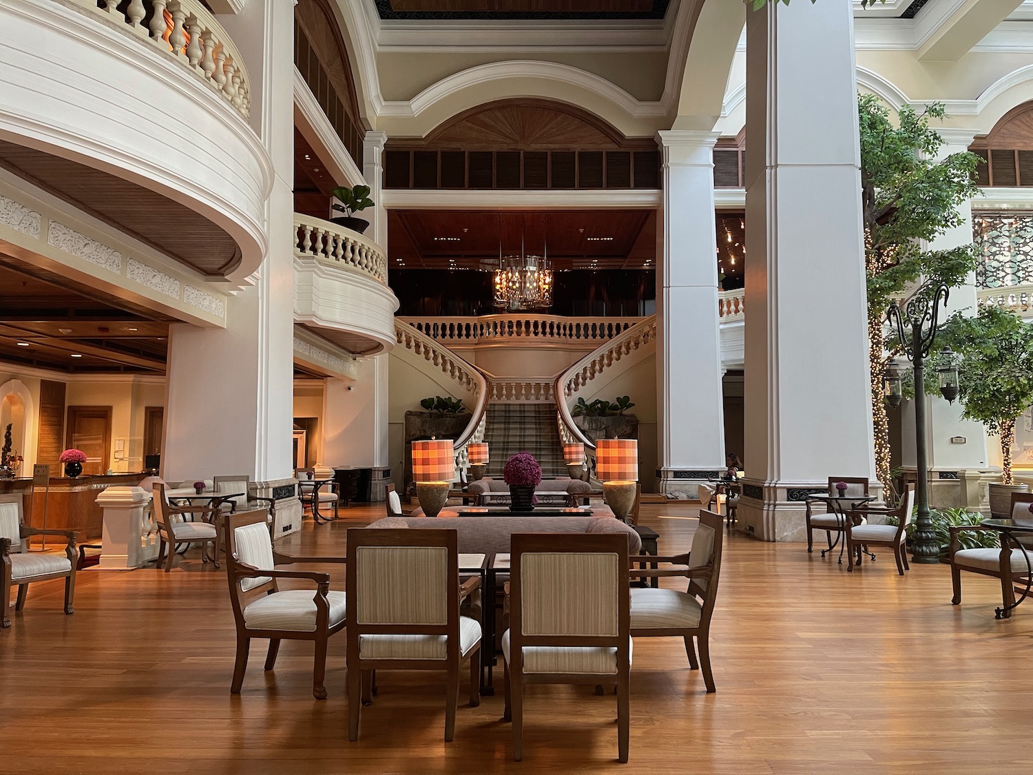 a large room with a staircase and a table and chairs