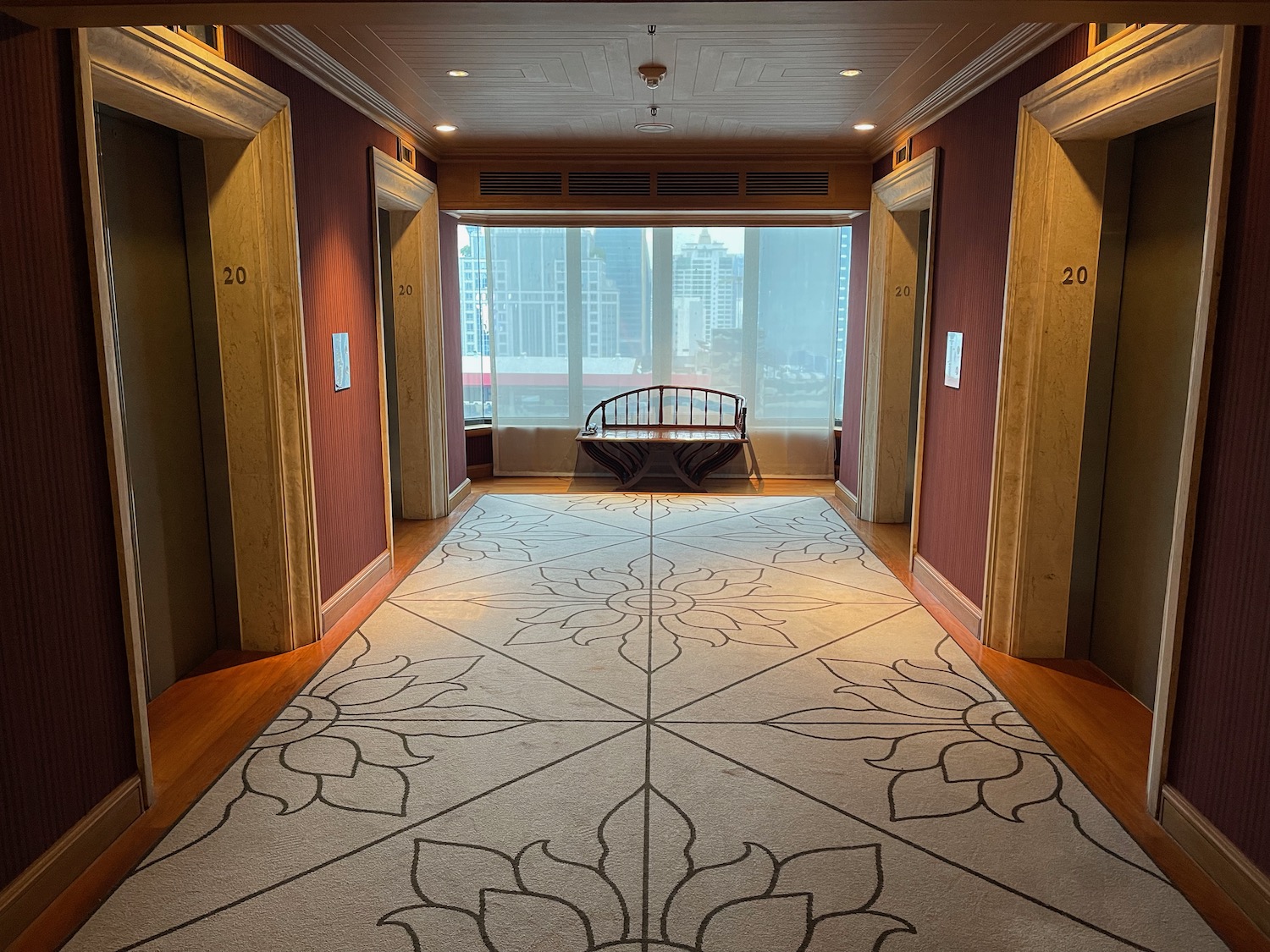 a hallway with a bench and a carpet