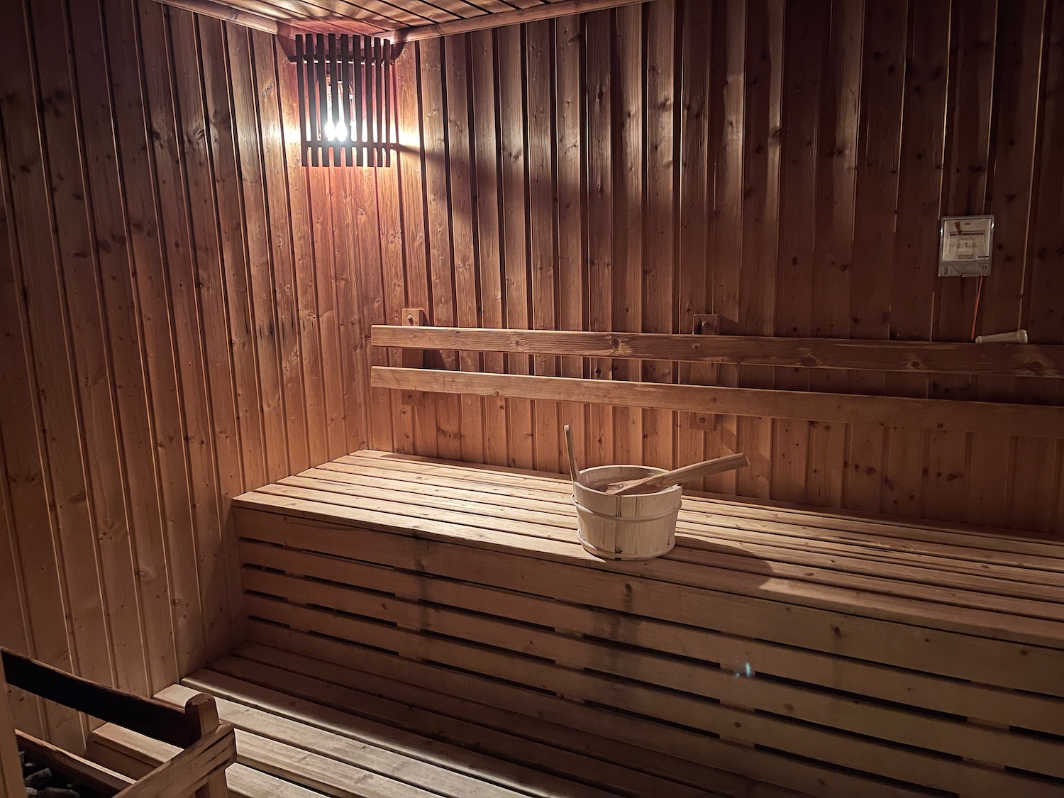 a wooden sauna with bucket and shovel