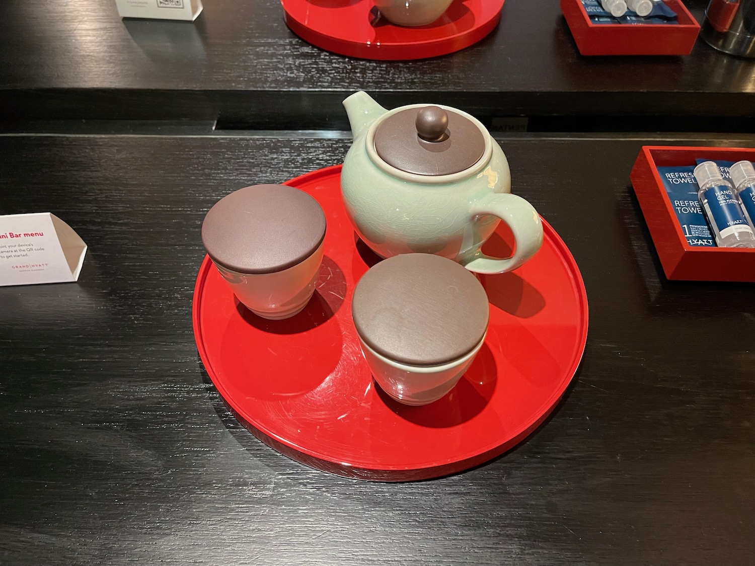 a tea set on a red tray