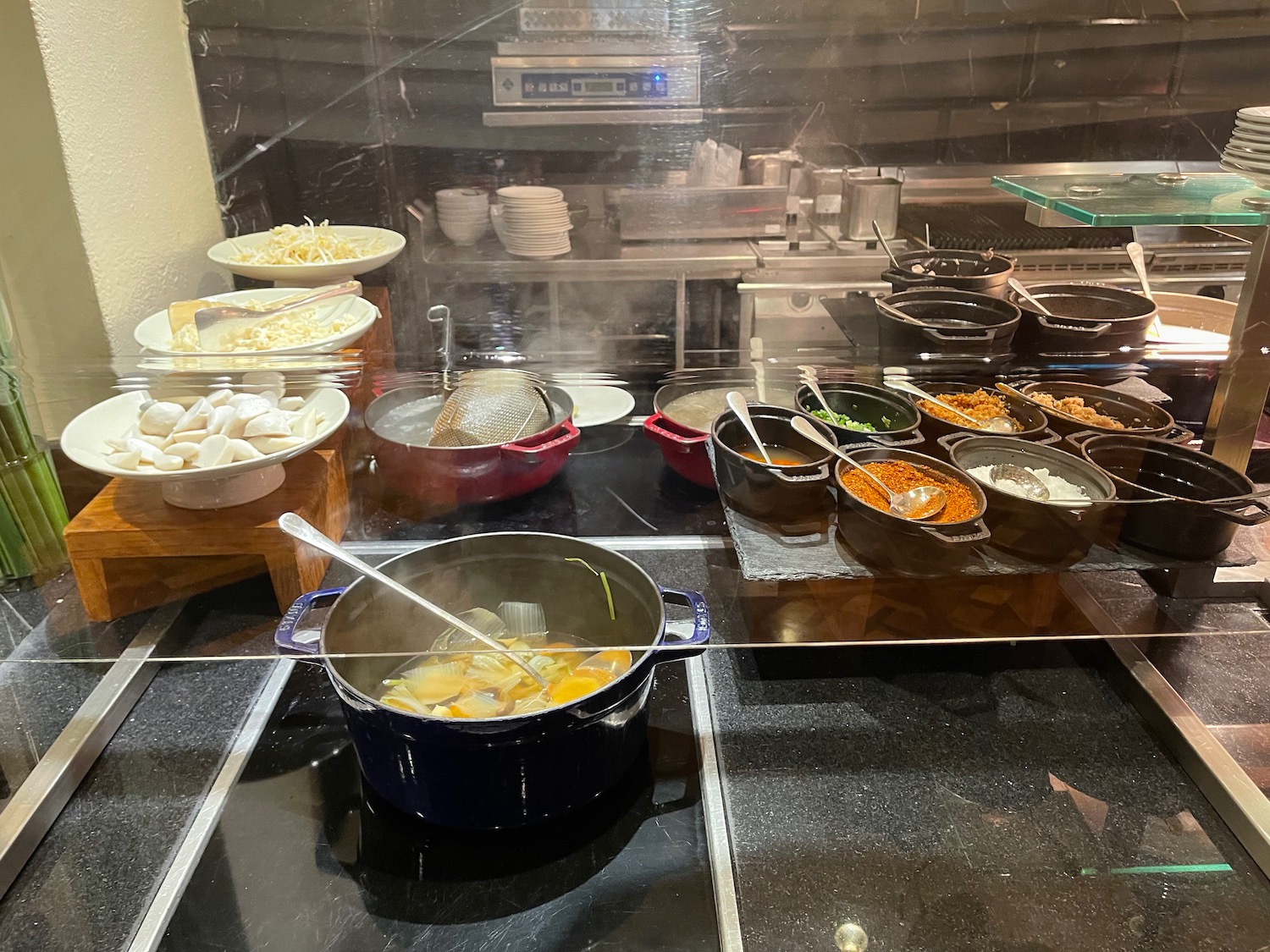 a kitchen with many pots of food