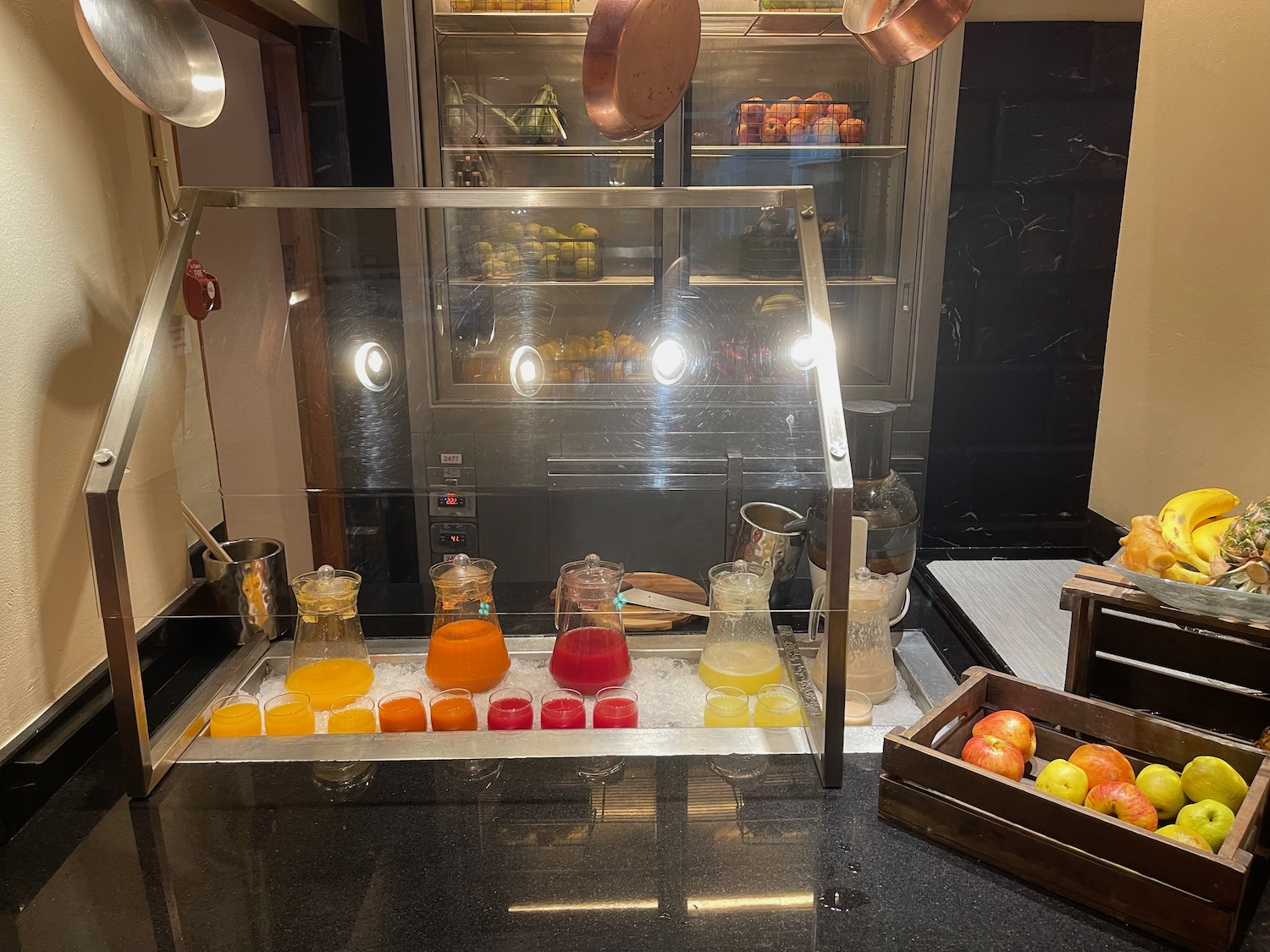 a counter with a glass container filled with orange juice