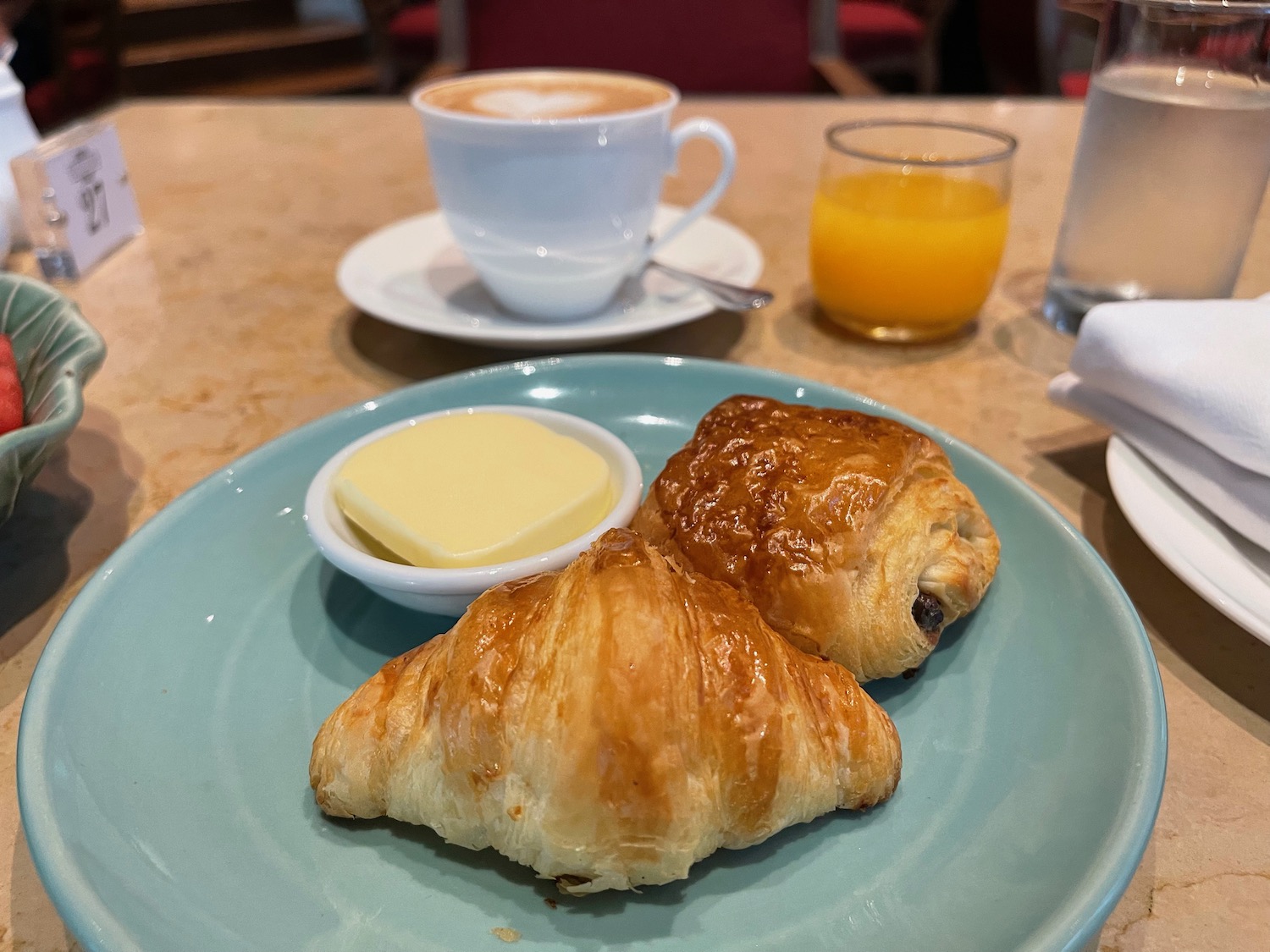 a plate of croissants and butter on a table