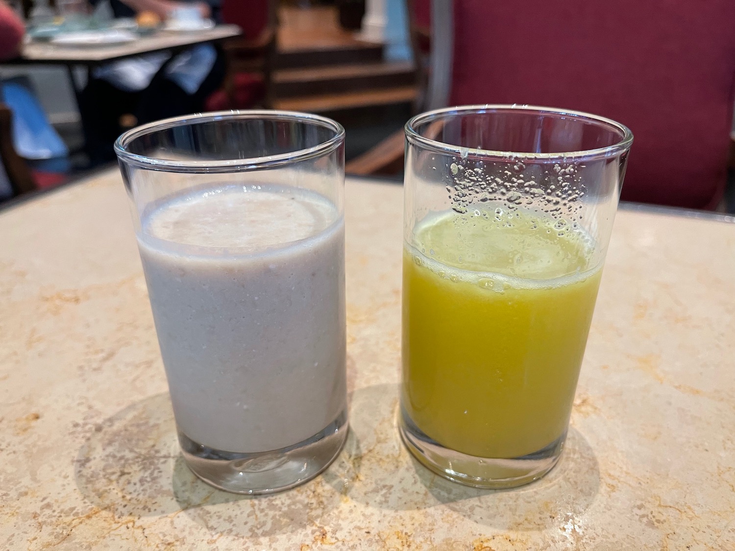 two glasses of milk and a yellow drink