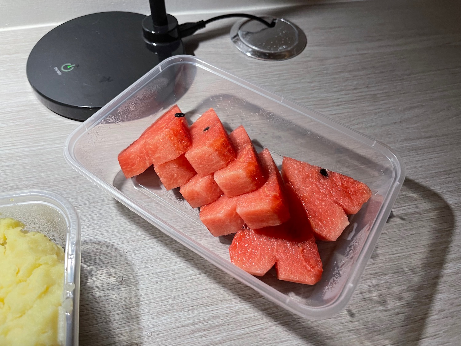 a watermelon slices in a plastic container