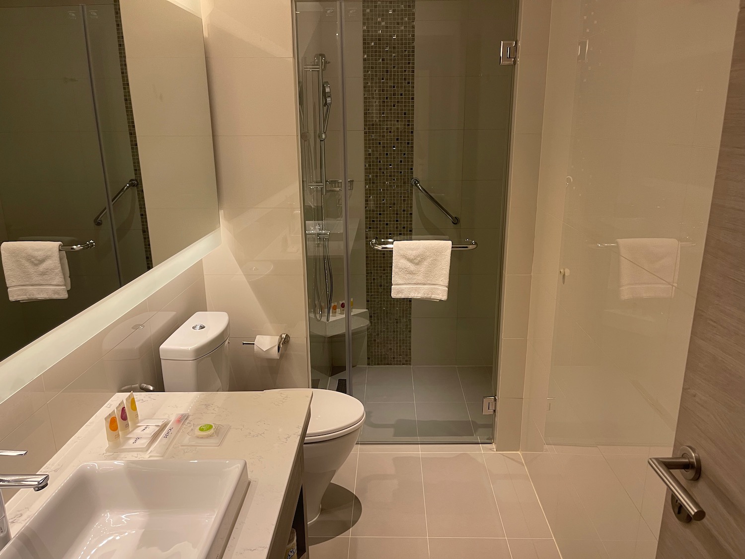 a bathroom with a glass shower door