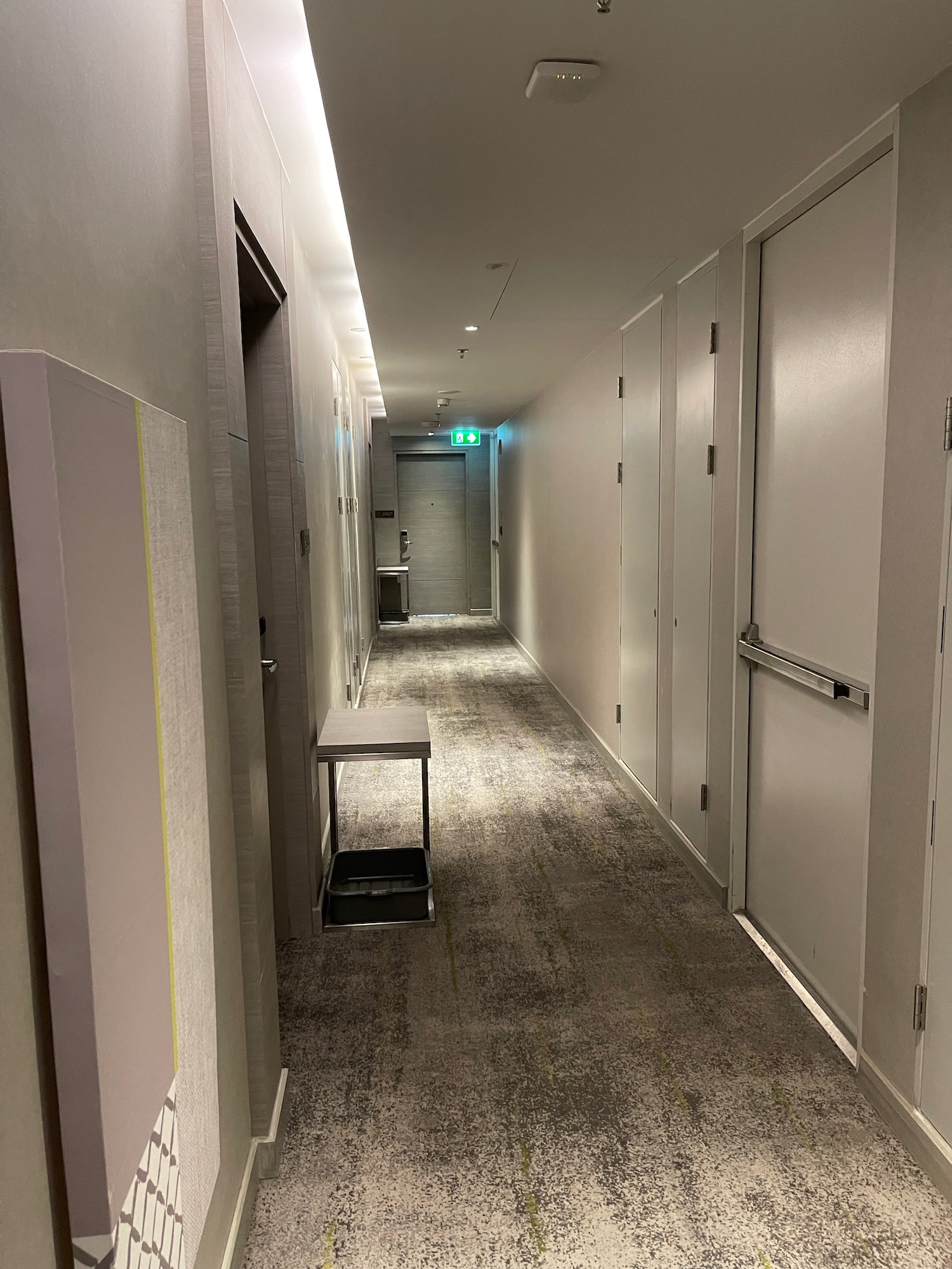 a hallway with doors and a table