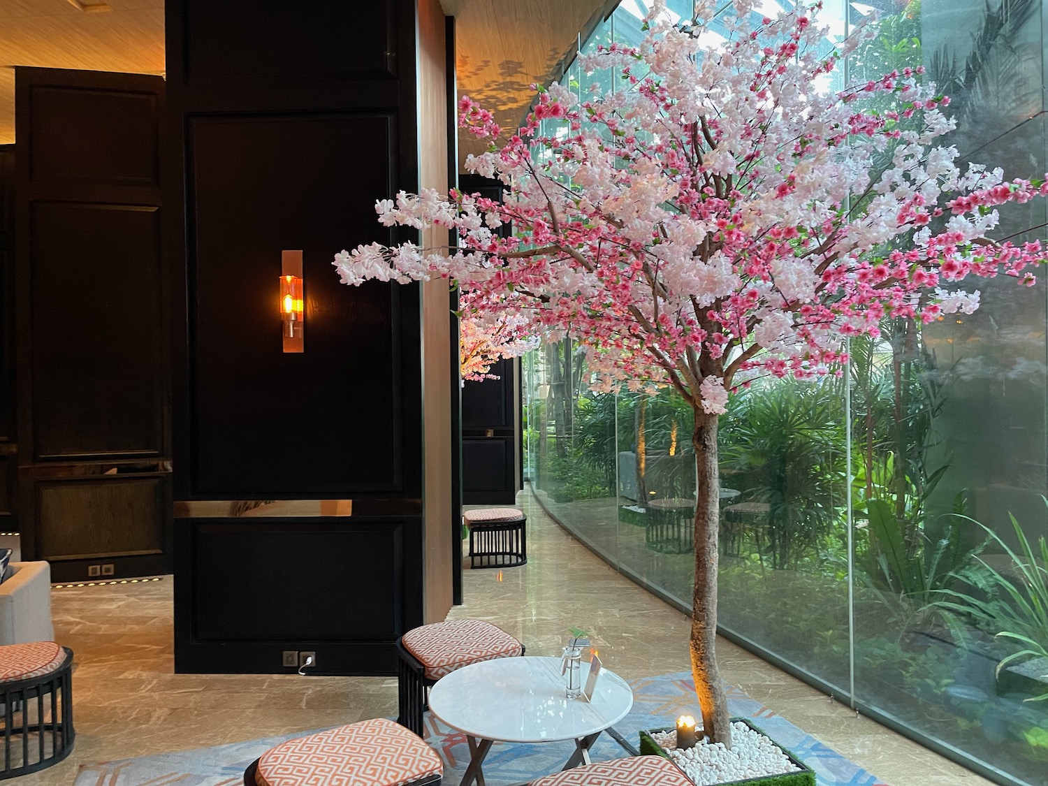 a tree with pink flowers in a room