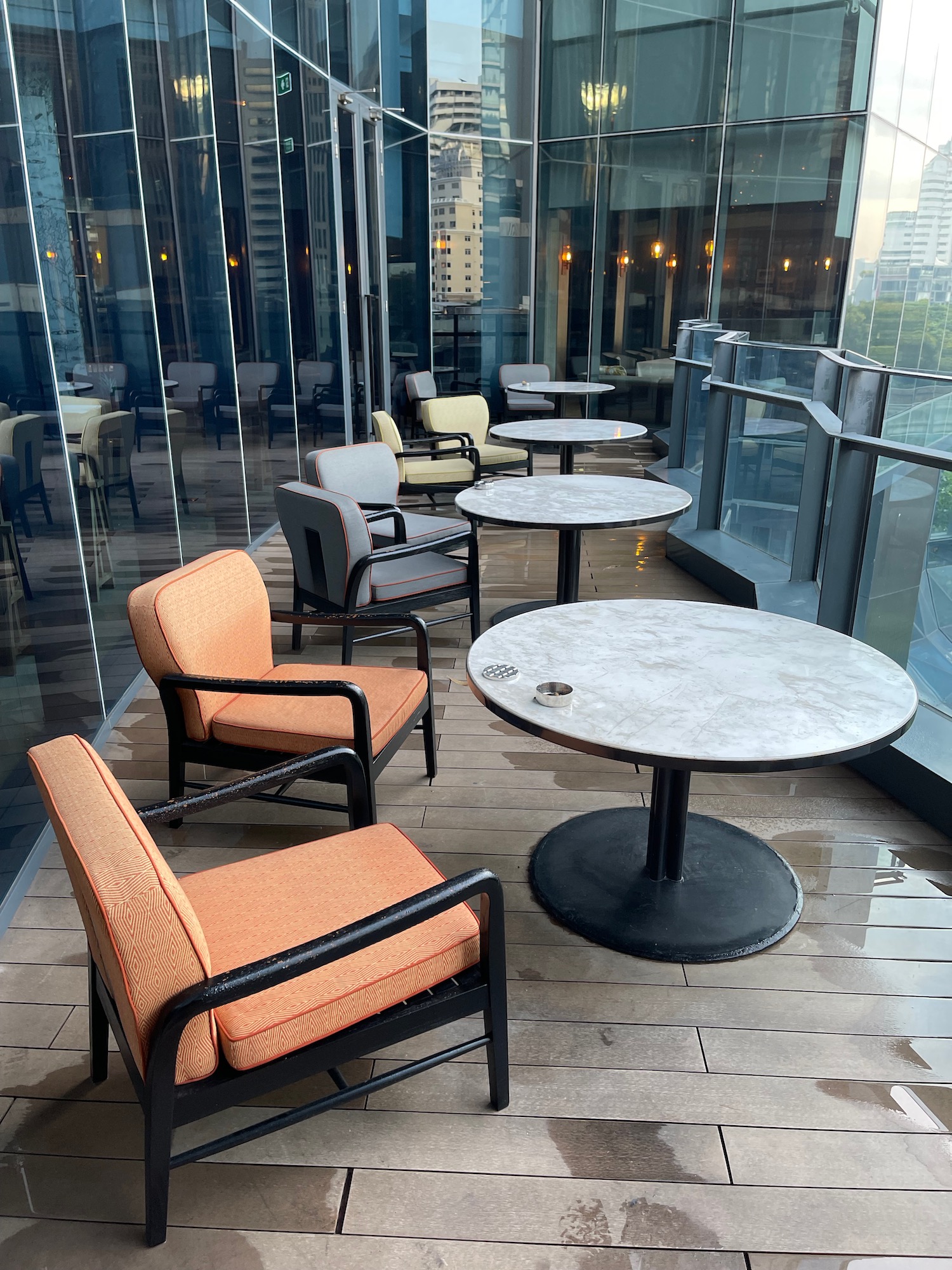 a group of chairs and tables on a balcony