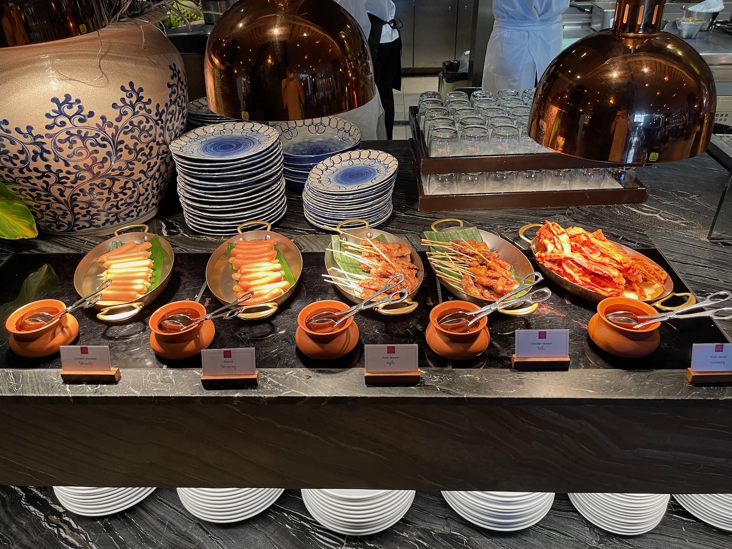 a buffet table with plates and food on it