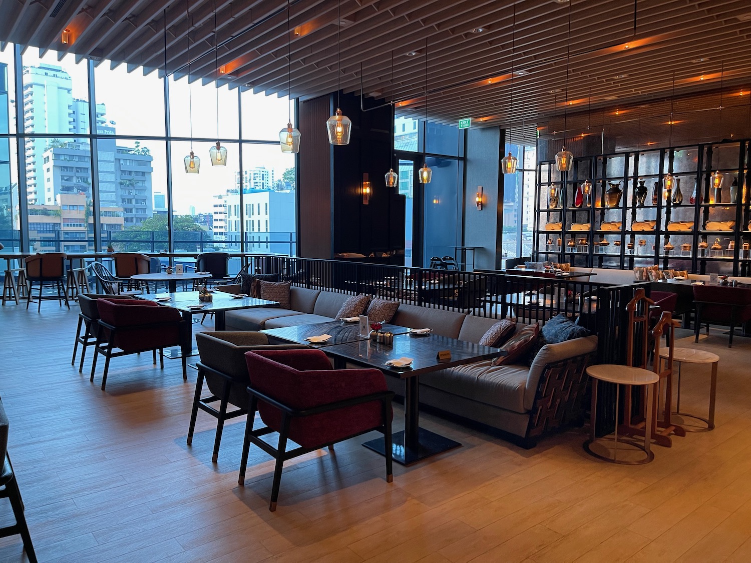 a room with a large window and tables and chairs