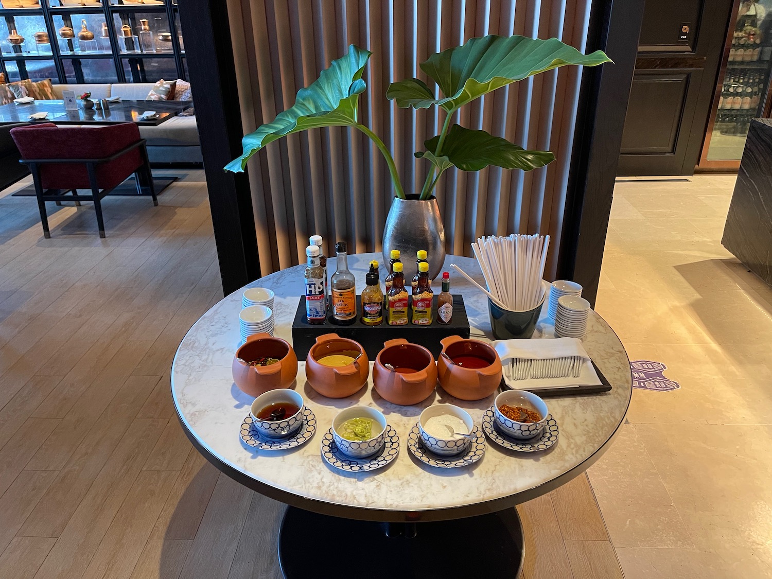 a table with a variety of sauces and condiments