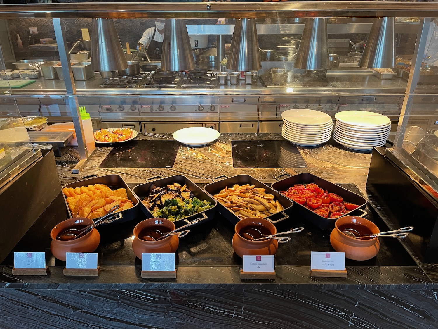 a buffet table with food in containers