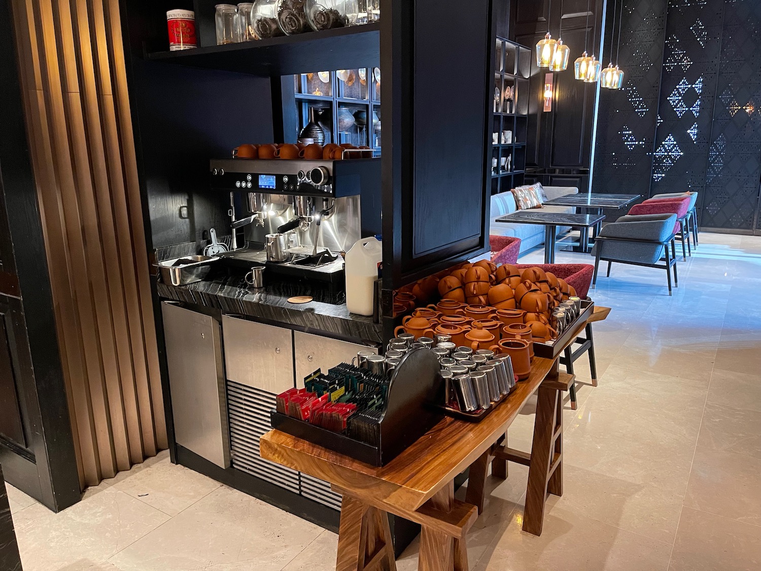 a coffee machine and utensils on a table