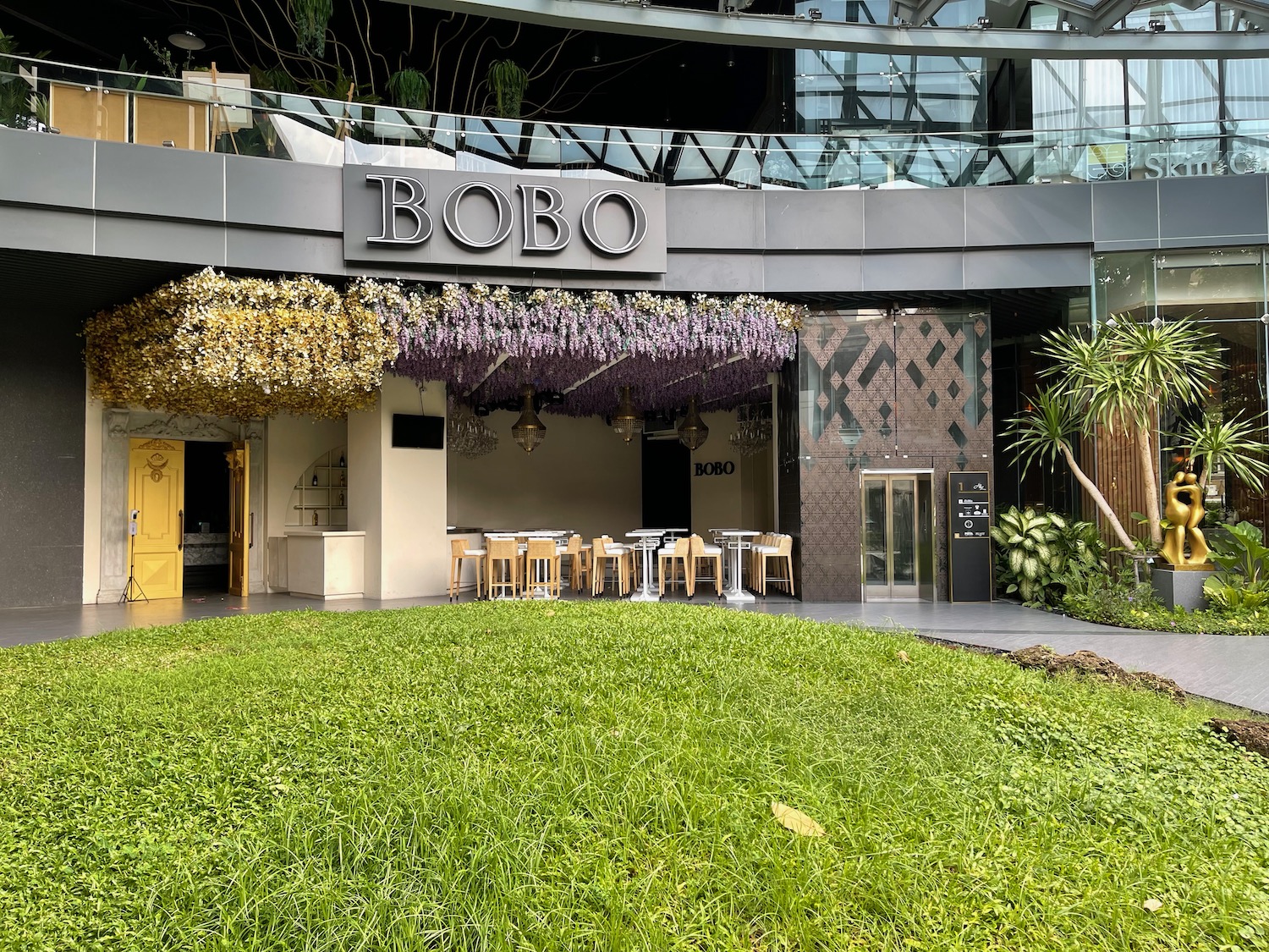 a building with a lawn and tables