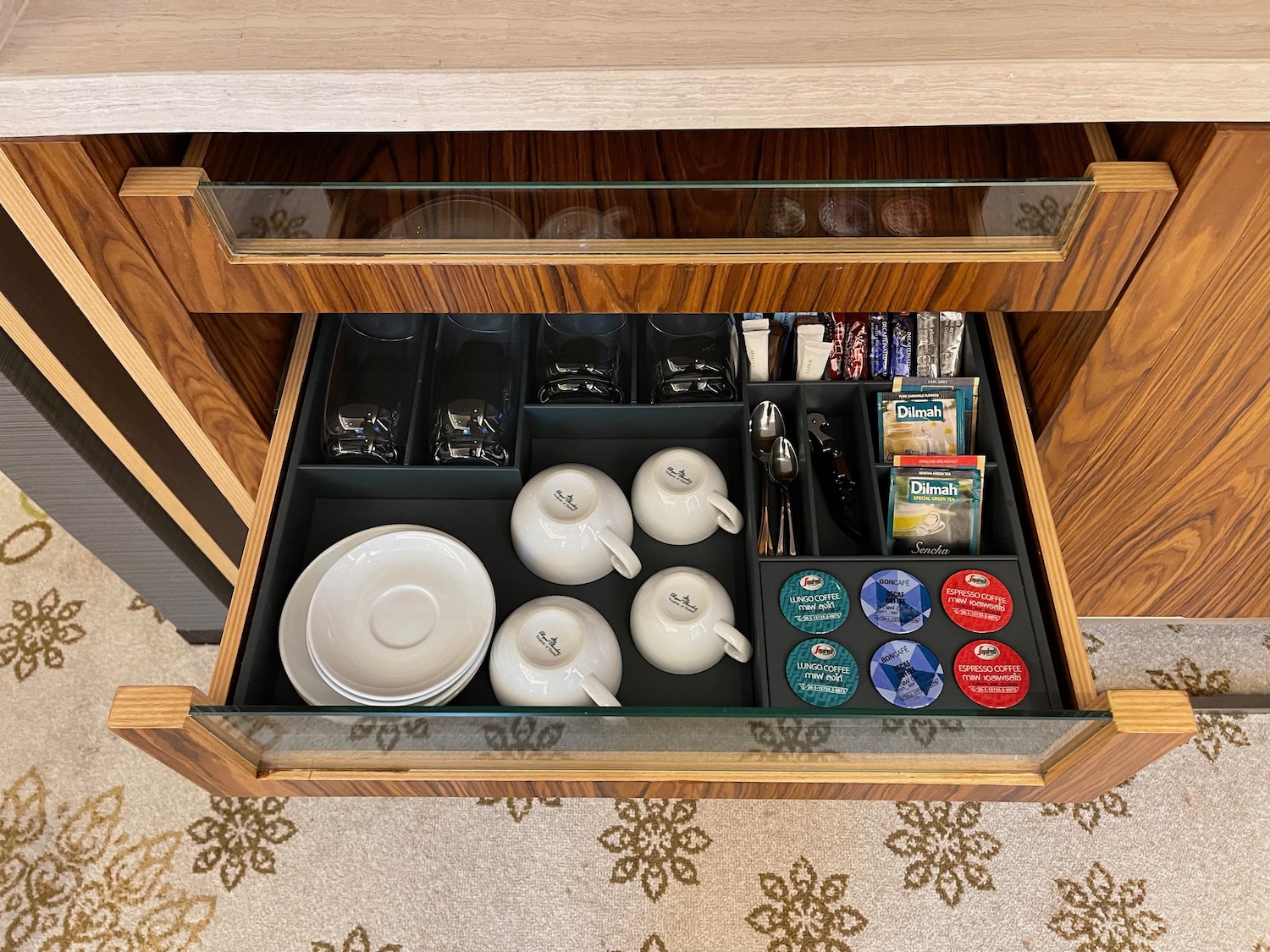 a drawer with tea cups and teacups