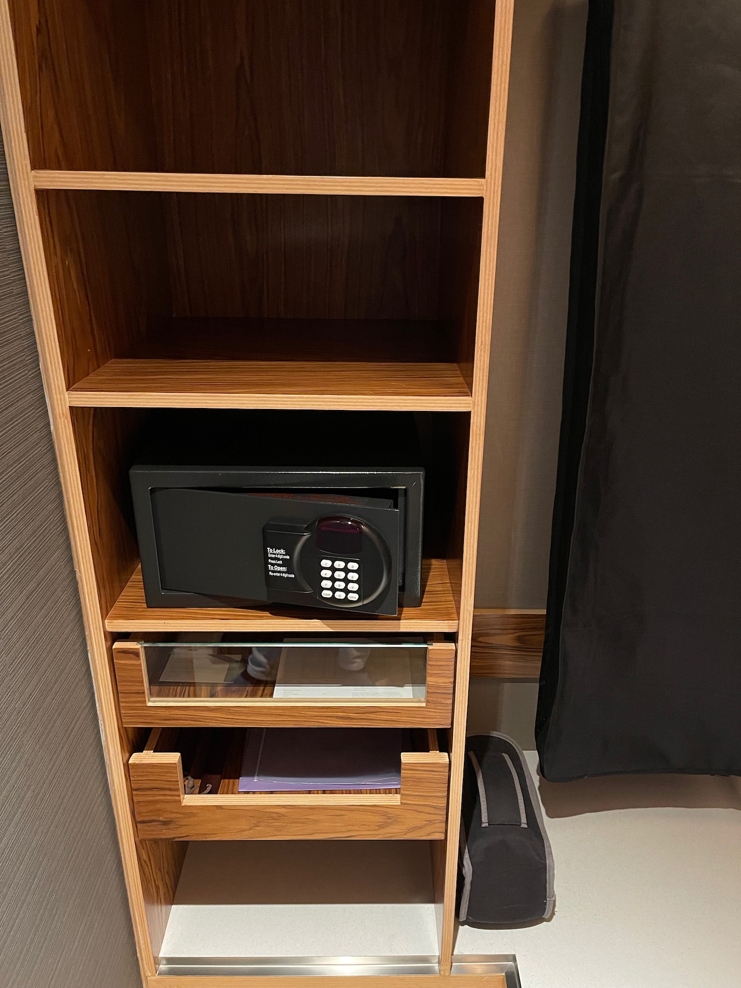 a wooden shelf with a combination lock and a black door