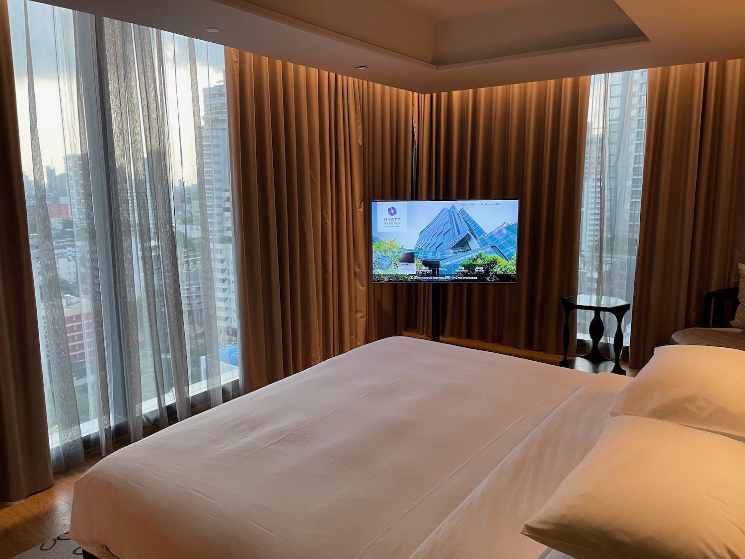 a bed with a television in the corner of a room