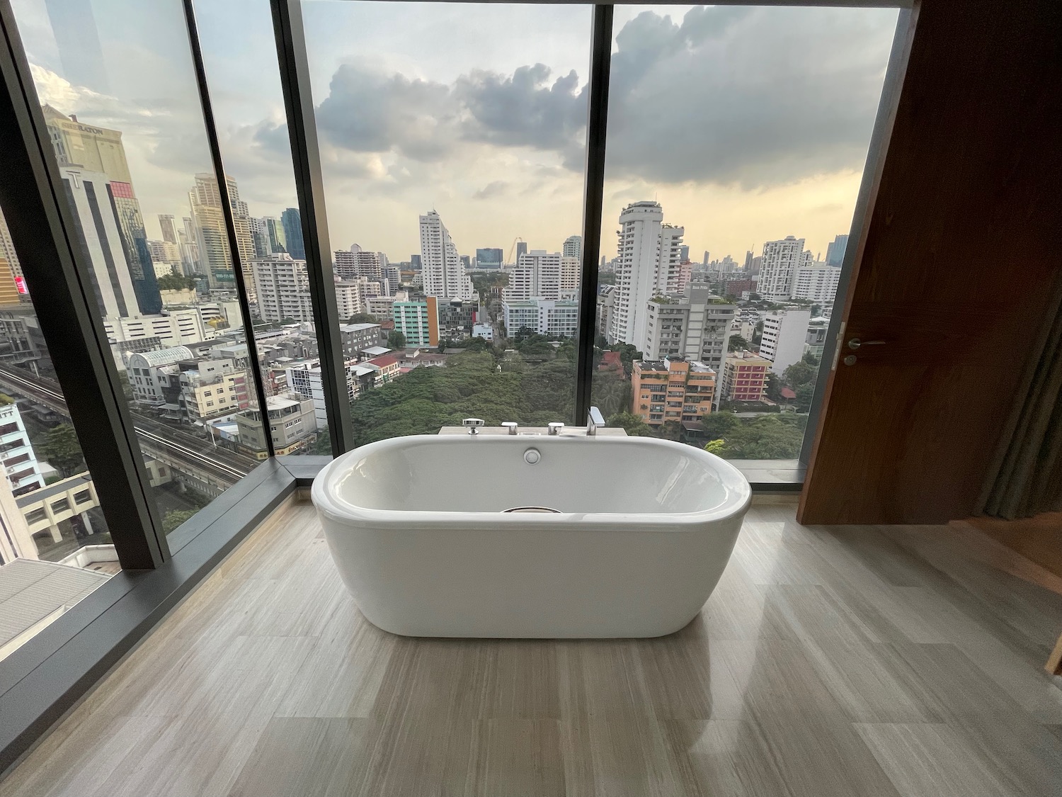 a bathtub in a room with a view of a city