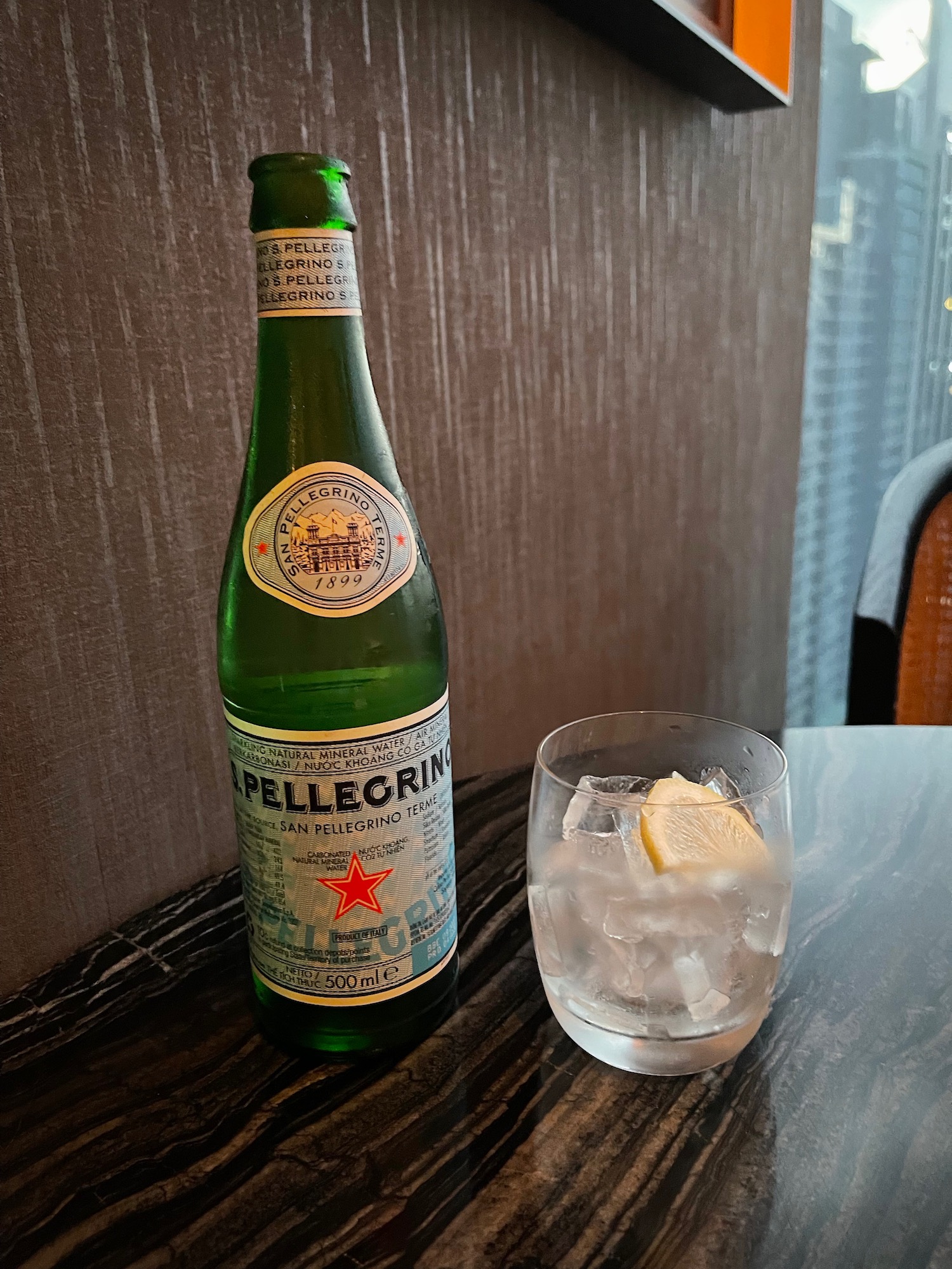 a bottle of beer and a glass of ice on a table