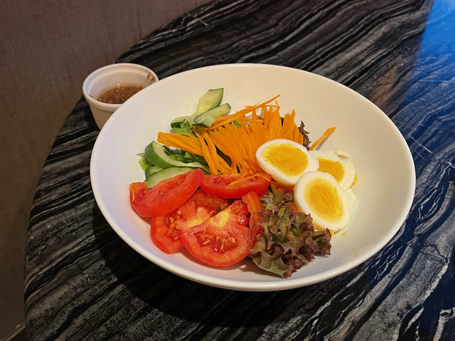 a bowl of salad with eggs and tomatoes