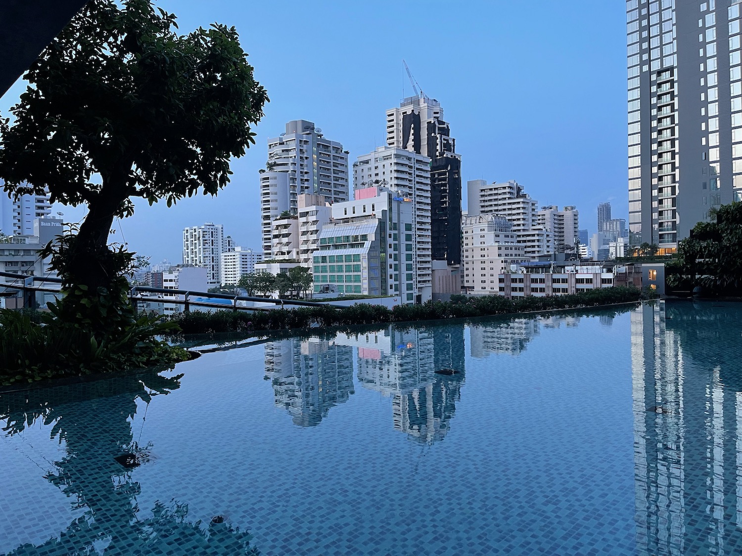 a city skyline with a pool of water