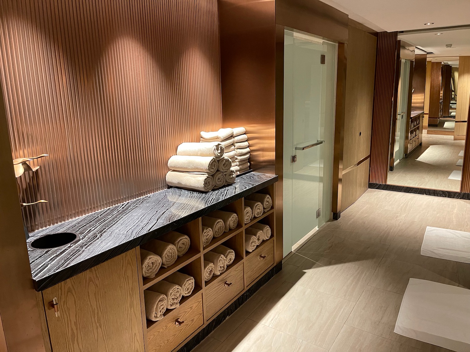 a room with towels on the shelves