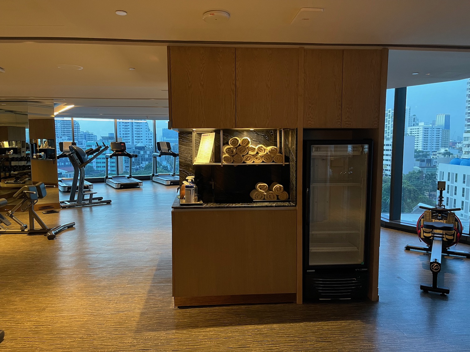 a gym with exercise equipment and a fridge