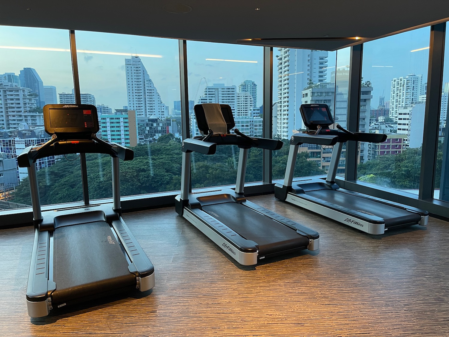 a group of treadmills in a room with a large window