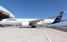 a large white airplane on a runway