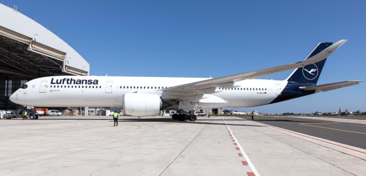 a large white airplane on a runway