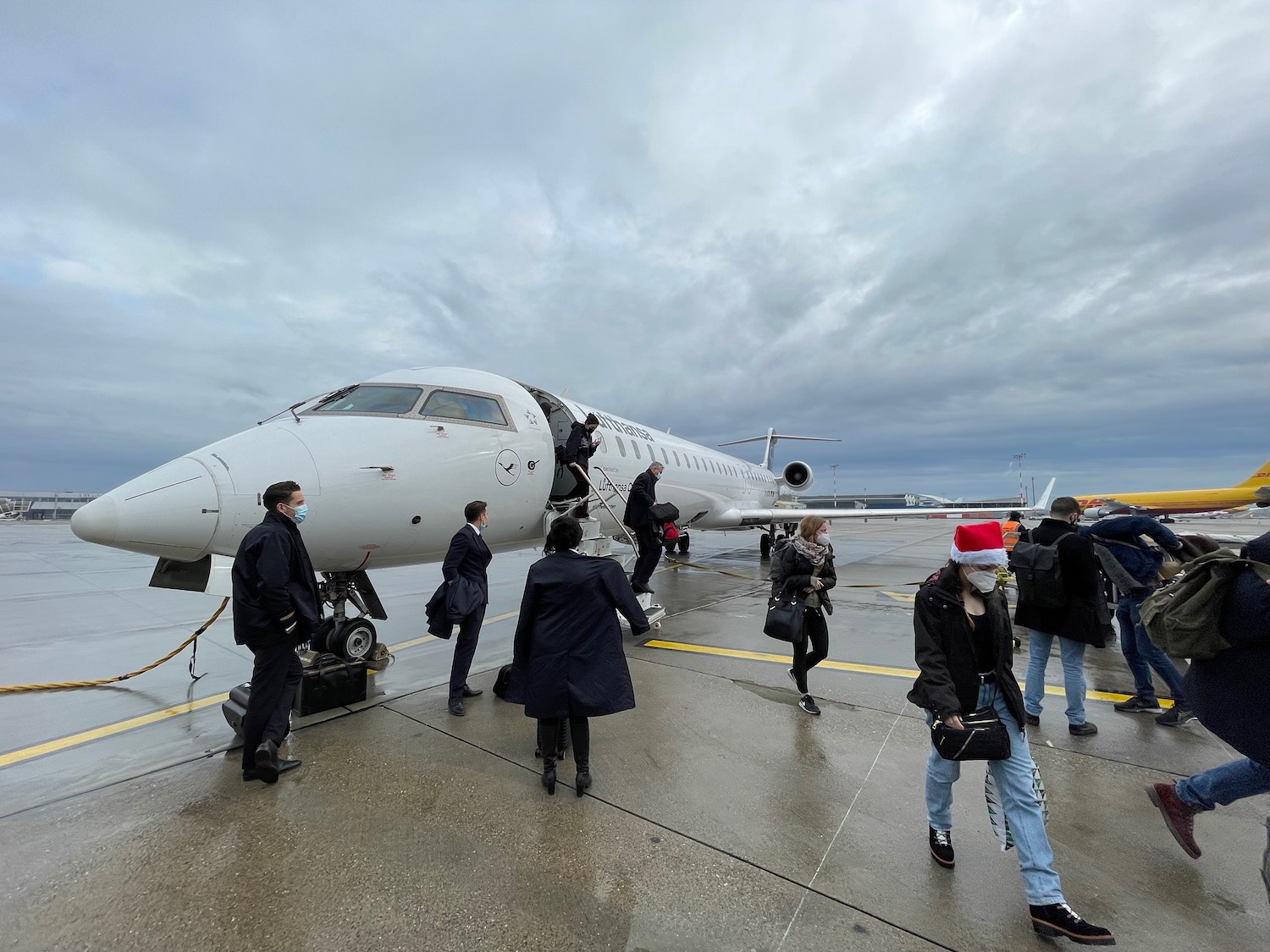 a group of people walking by an airplane