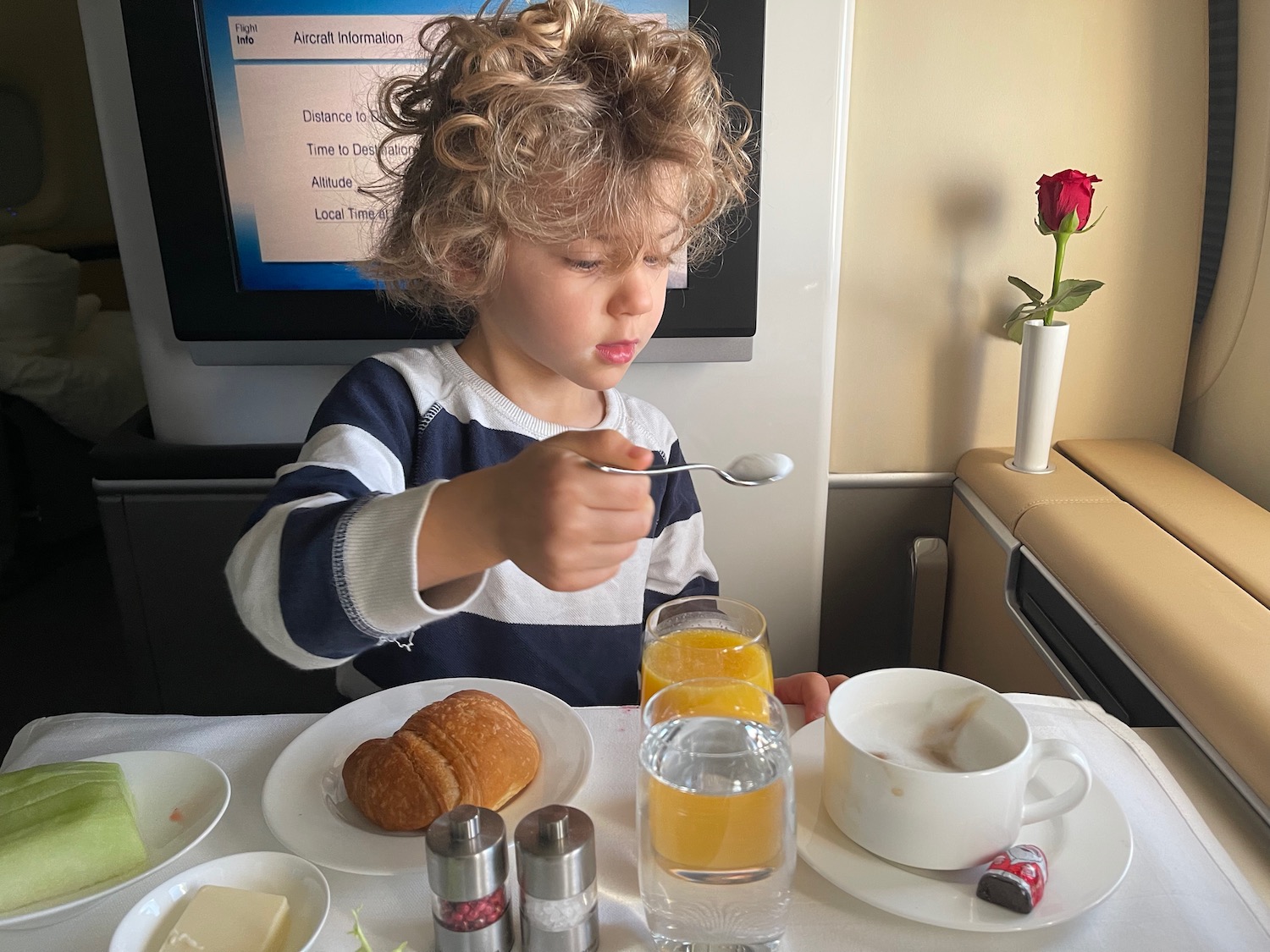 a child eating breakfast on an airplane