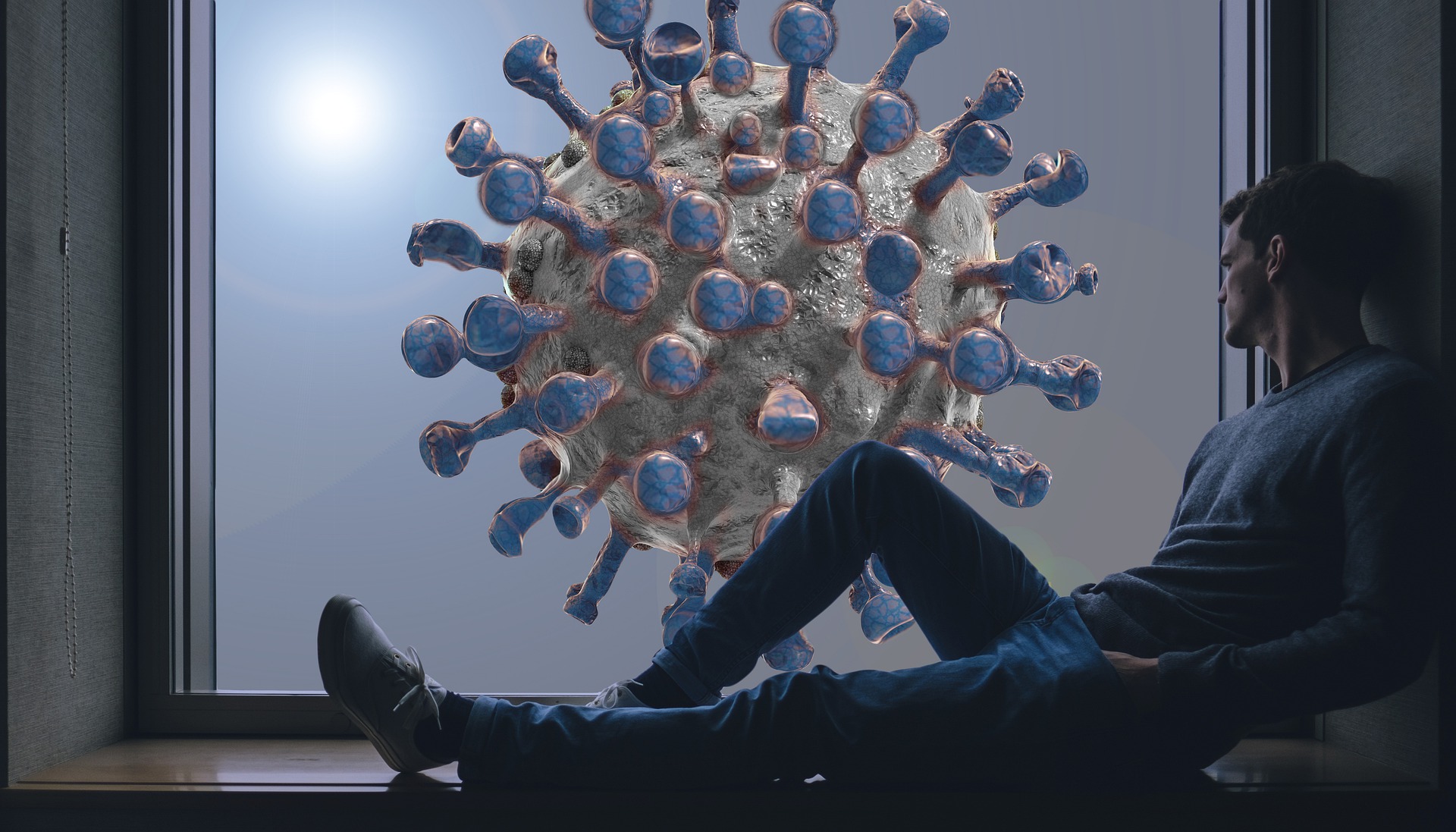 a person lying on the floor next to a large virus