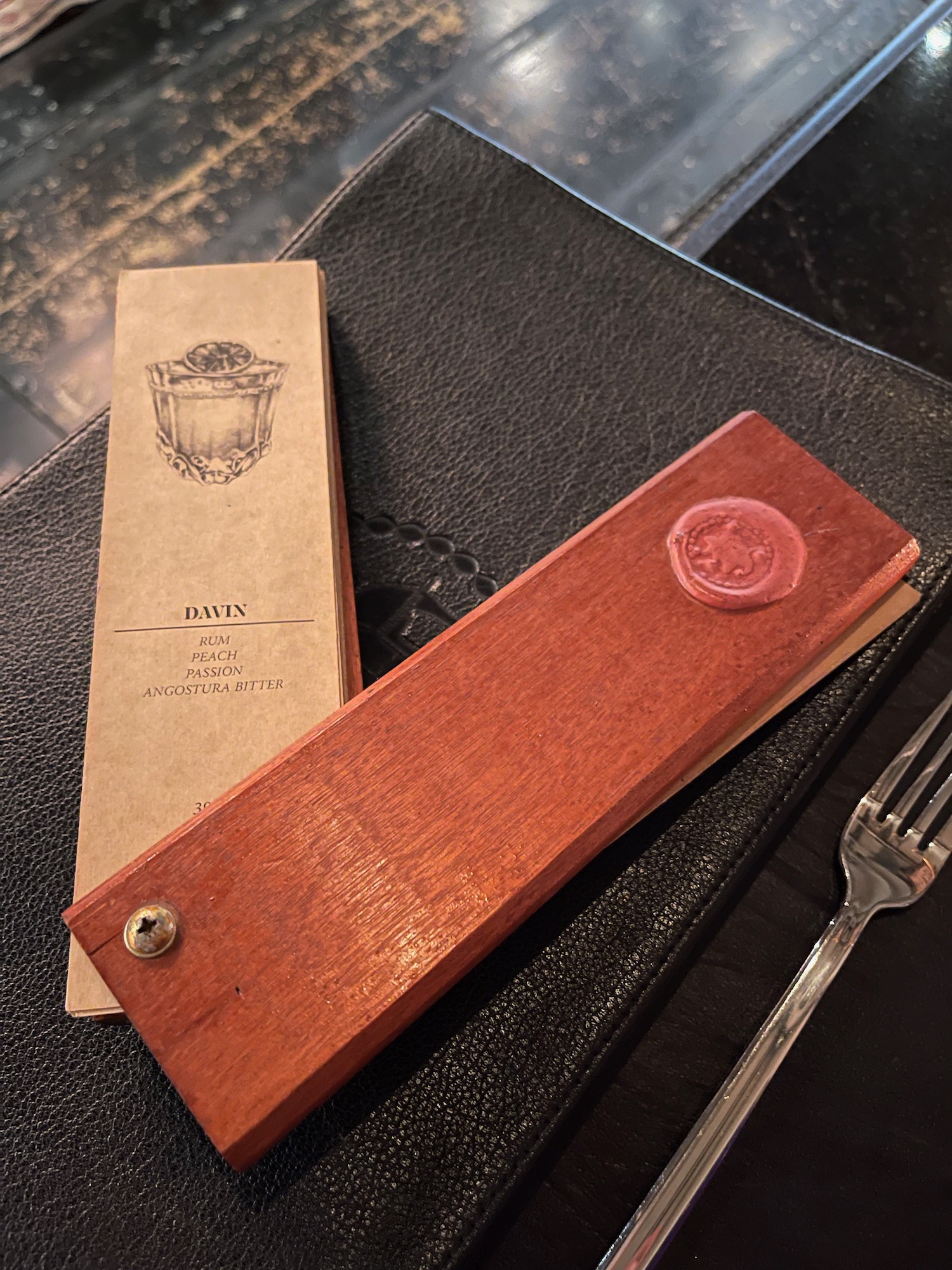 a menu and fork on a table