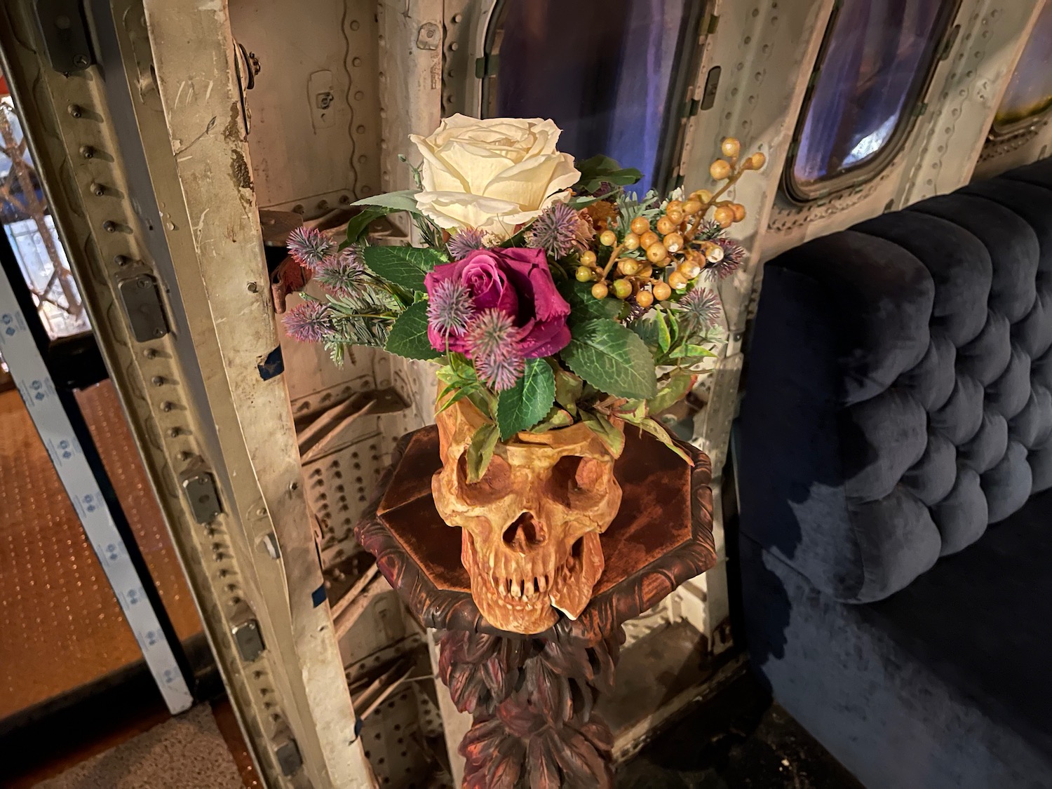 a skull with flowers in a vase