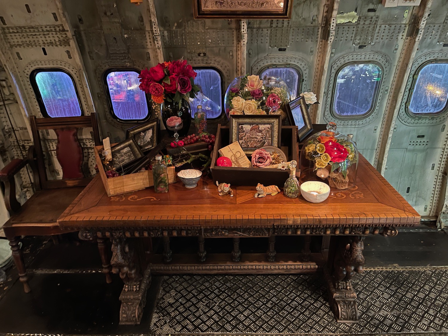 a table with flowers and other objects on it