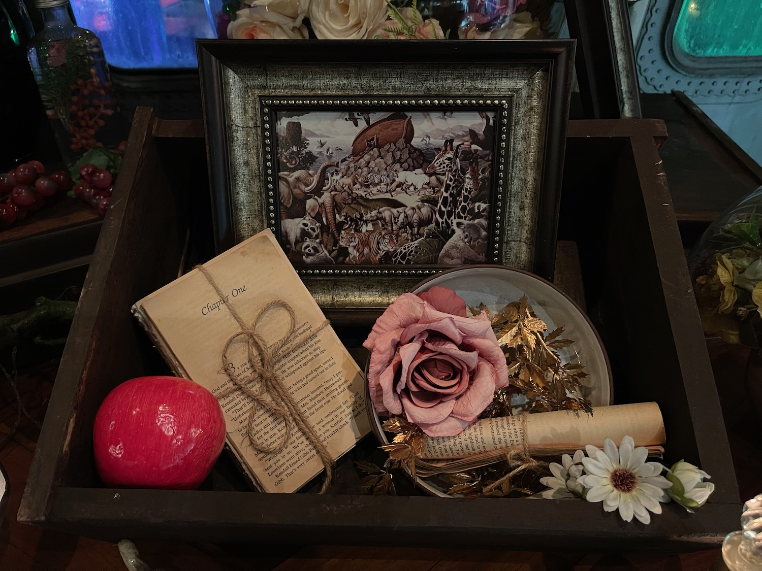 a box with a picture and a rose and a picture frame