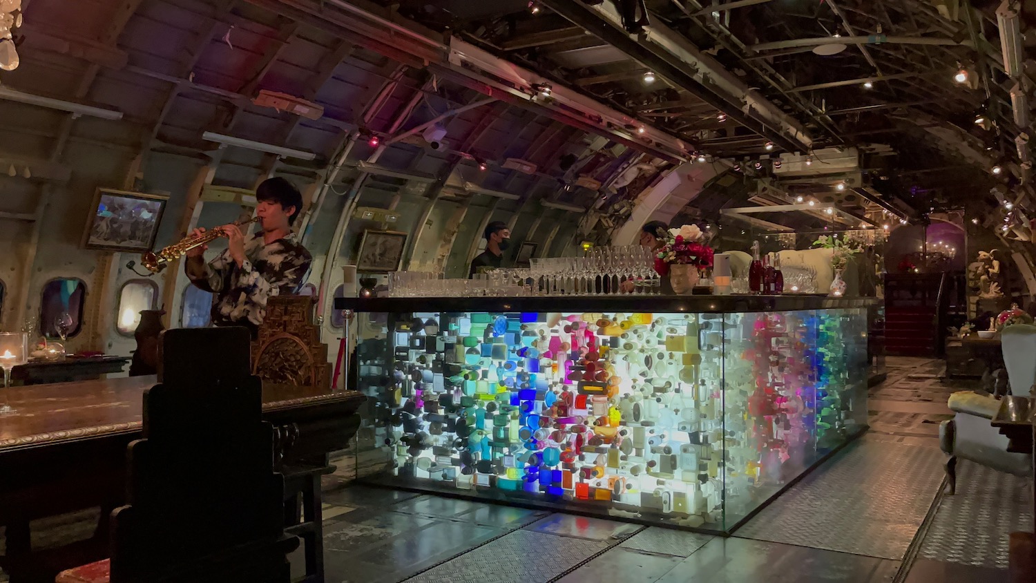 a bar with many bottles and glasses