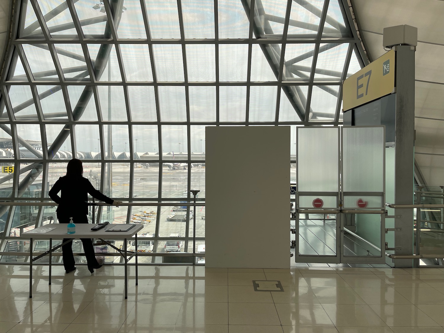 a person standing in a room with glass walls and a window