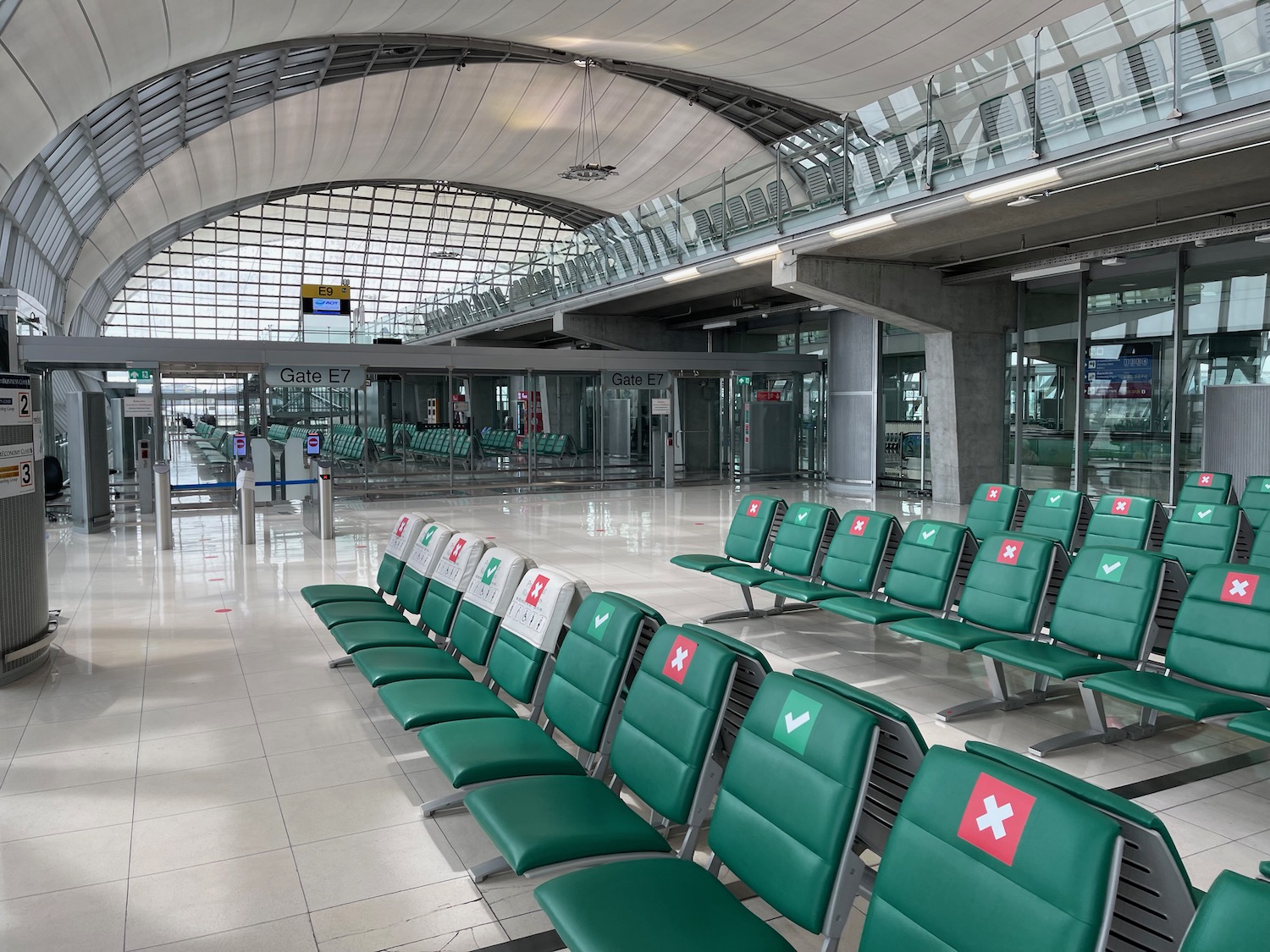 a row of green chairs in a terminal