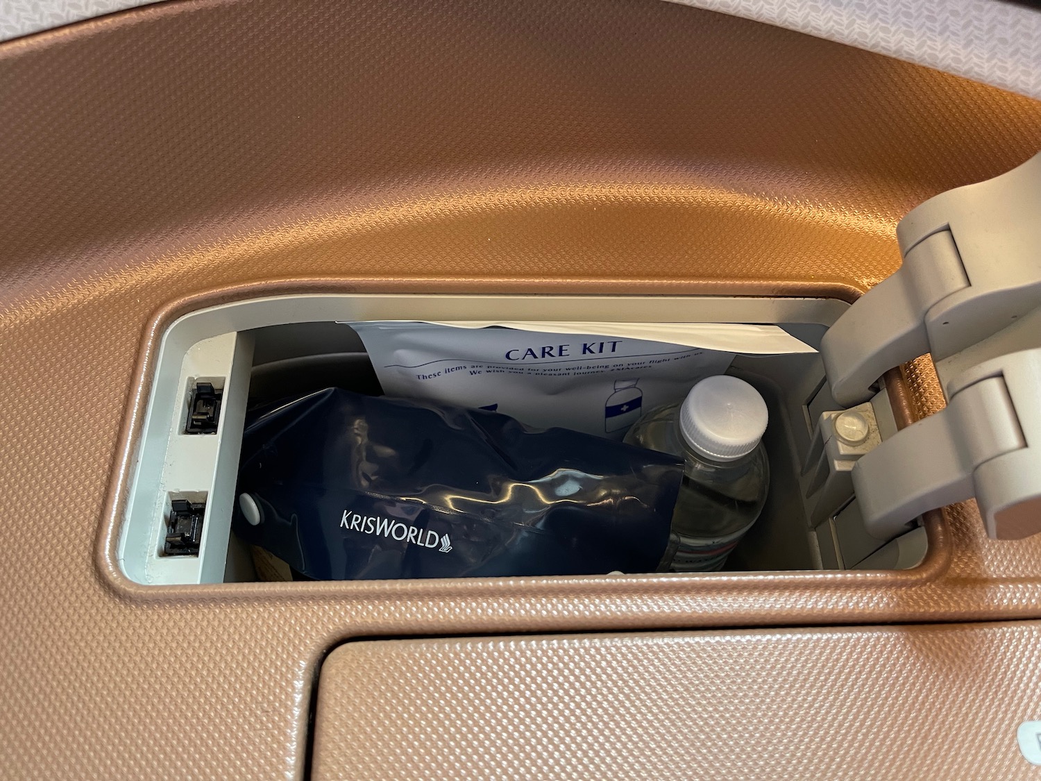 a small plastic bag with a bottle in the middle of a seat