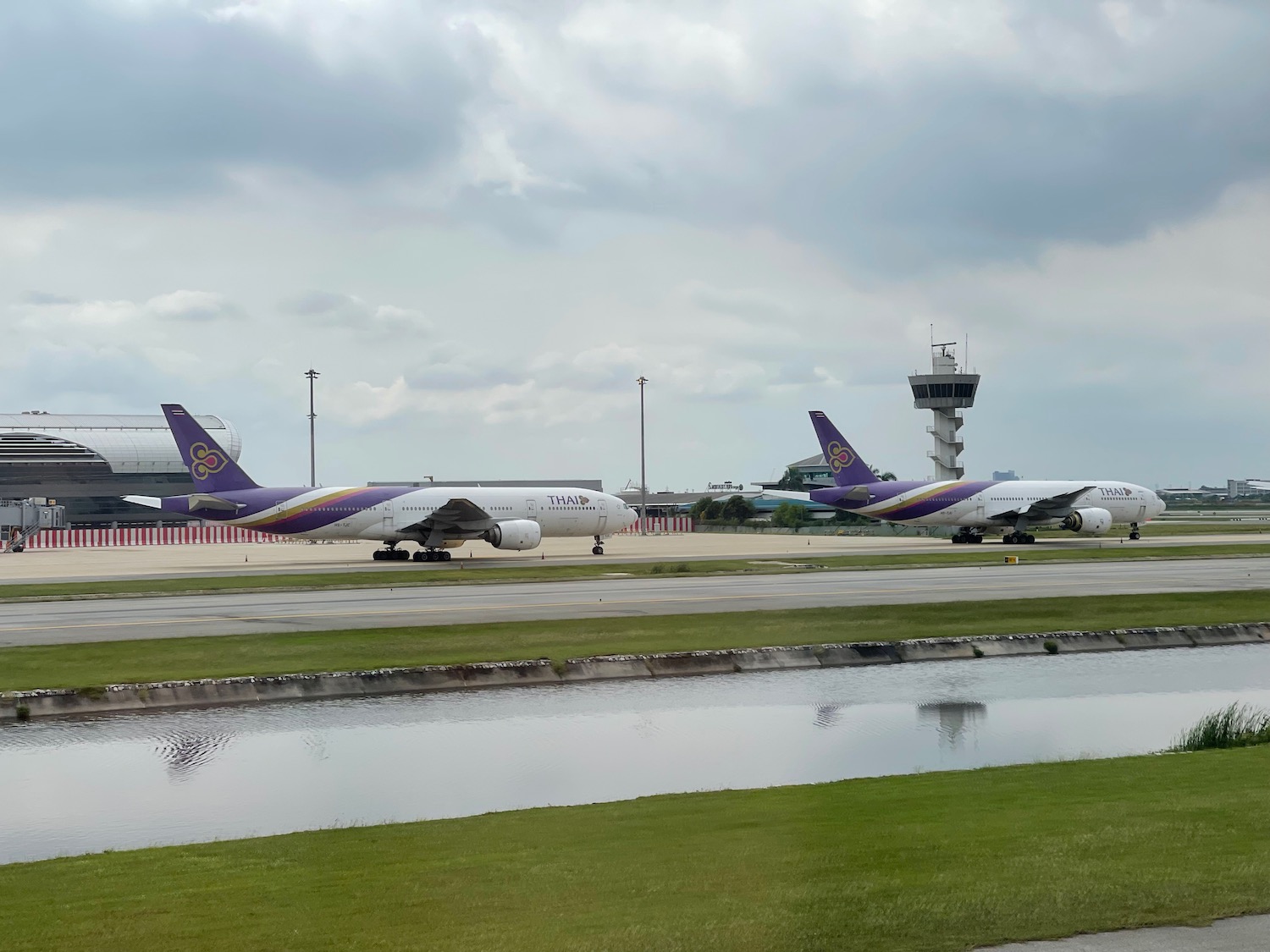 a group of airplanes on a runway