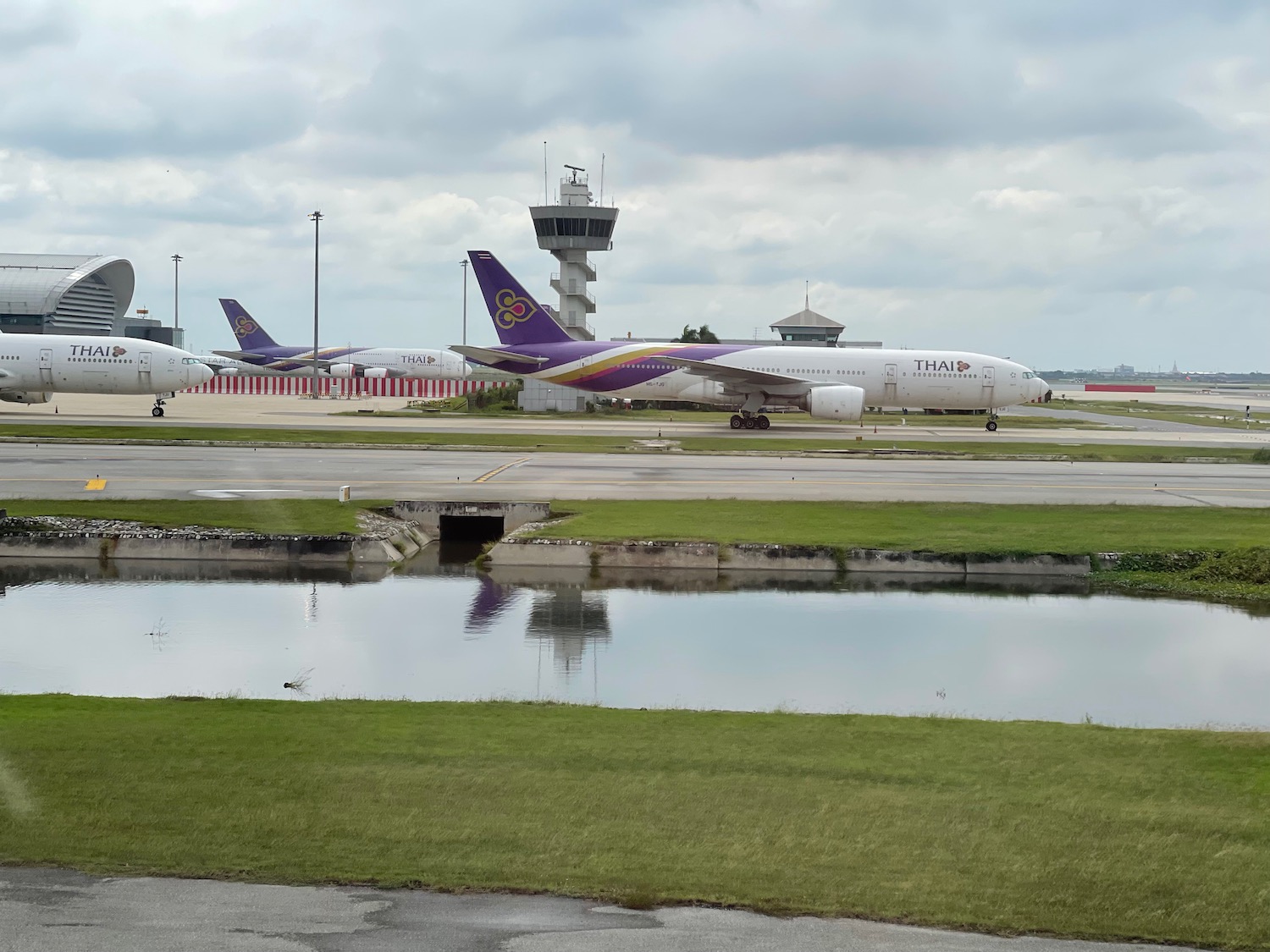 a group of airplanes on a runway