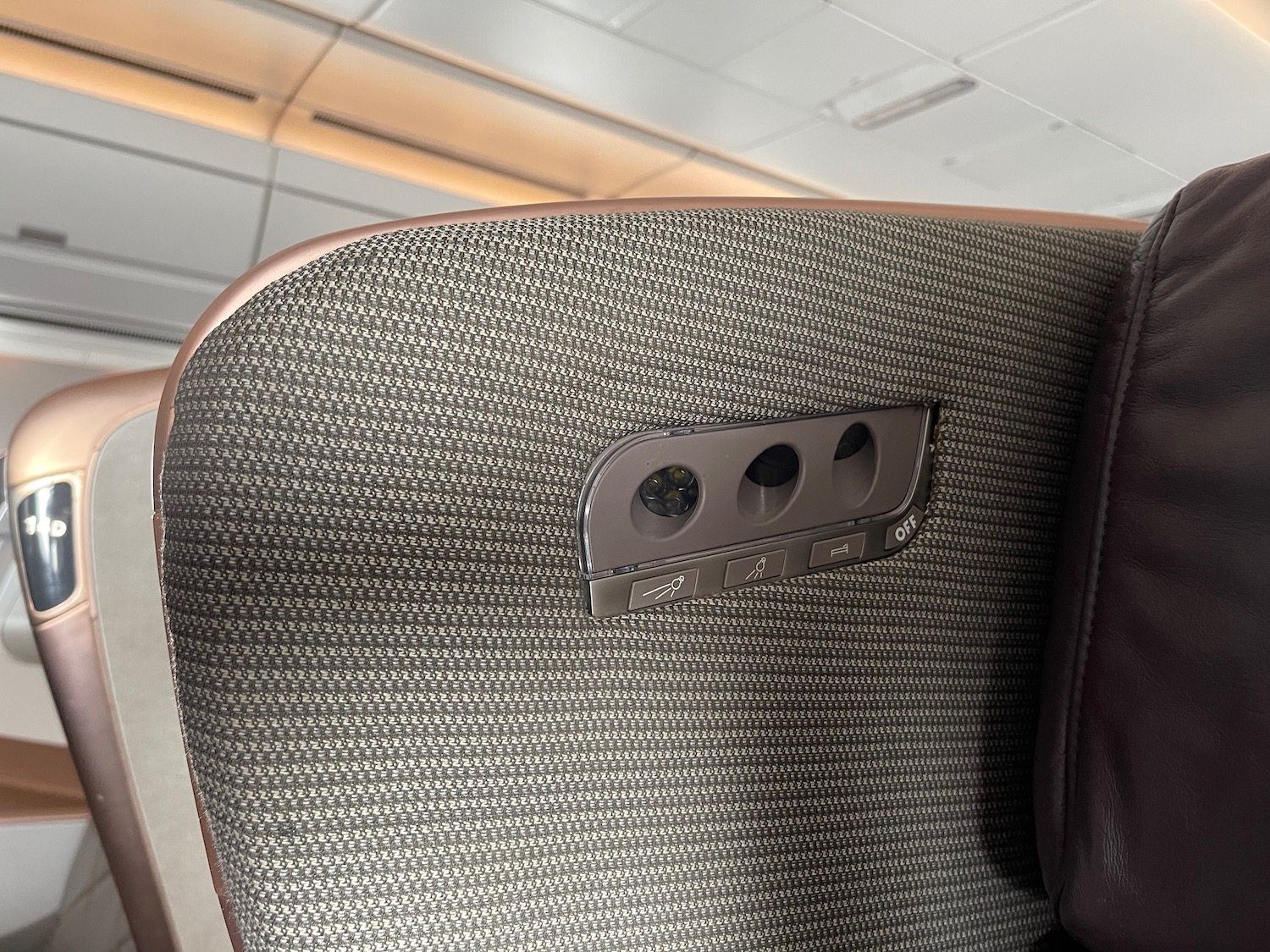 a seat with a button and a hole in the middle