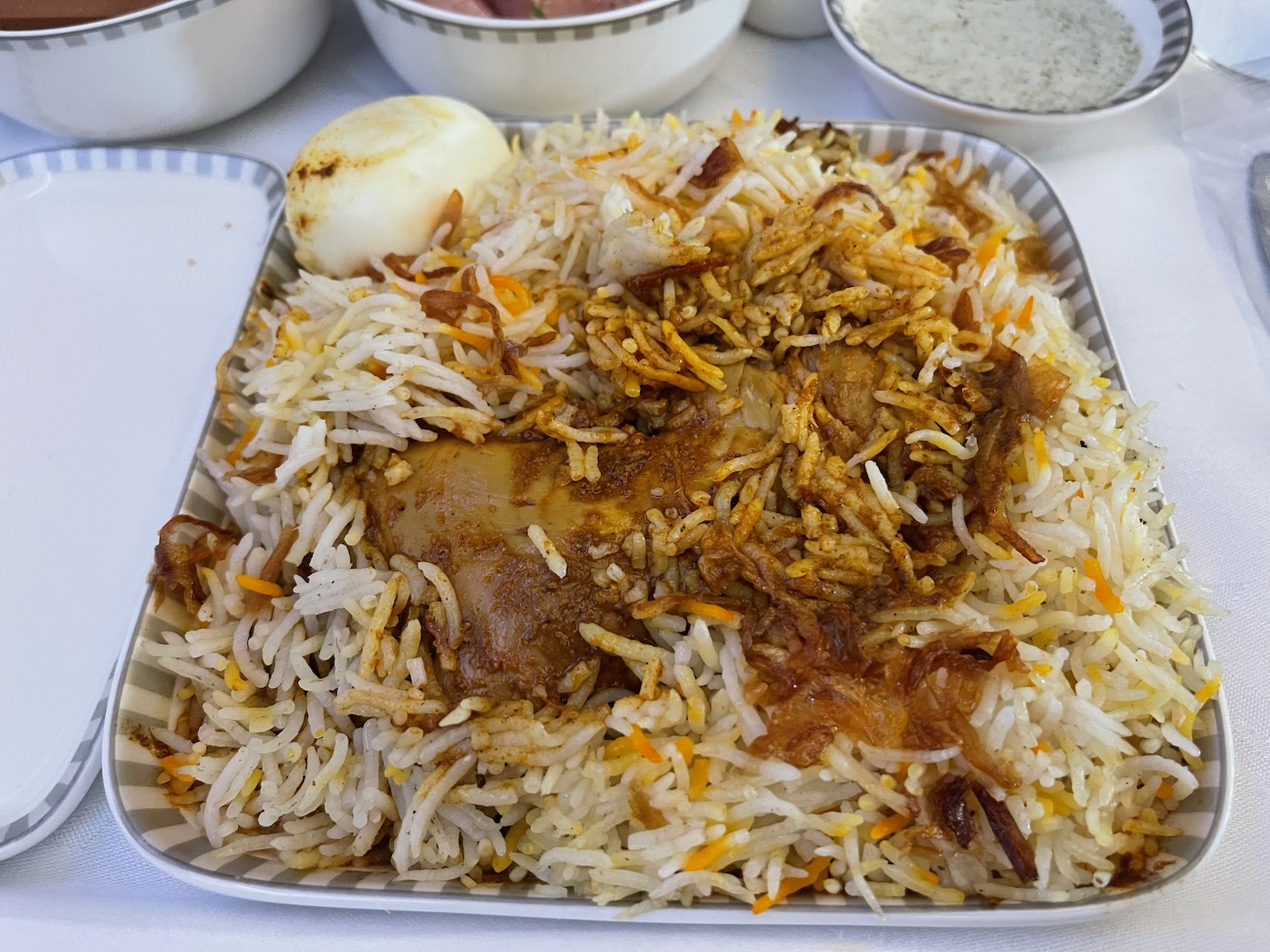 a plate of rice with meat and vegetables